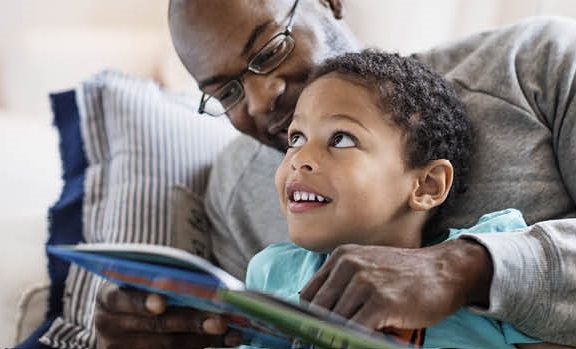 Adult and child reading book