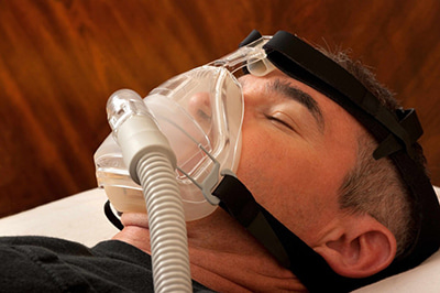 Person wearing CPAP mask for sleep apnea