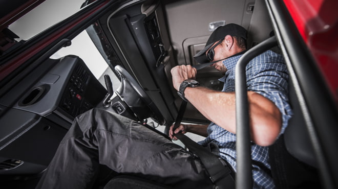 Person buckling up in big truck
