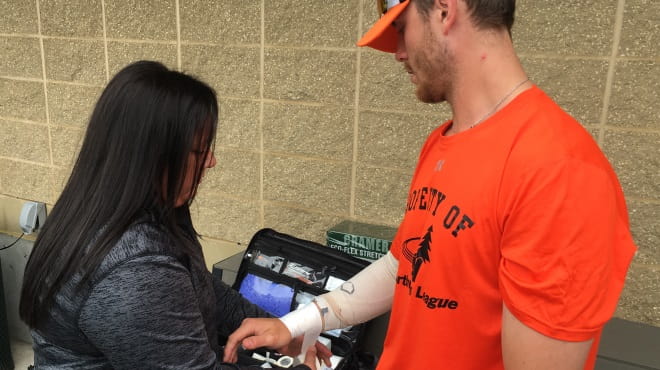 Athletic trainer taping wrist