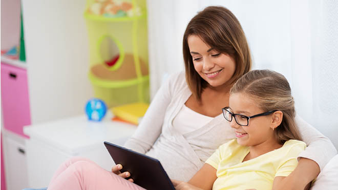 Mother and daughter looking at tablet