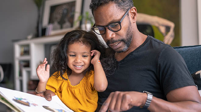 Child and parent reading a book