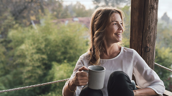 Enjoying a cup of coffee sitting outdoors