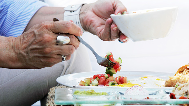 Forking vegetable salsa on plate