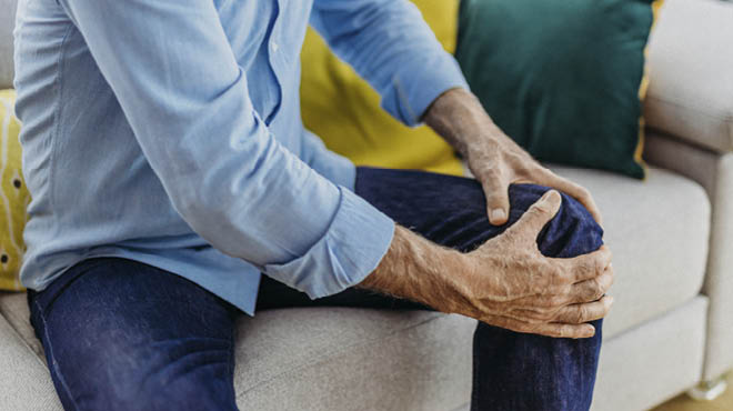 Hands holding knee; total knee replacement