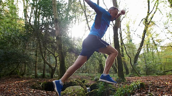 Jumping over rocks wooded area