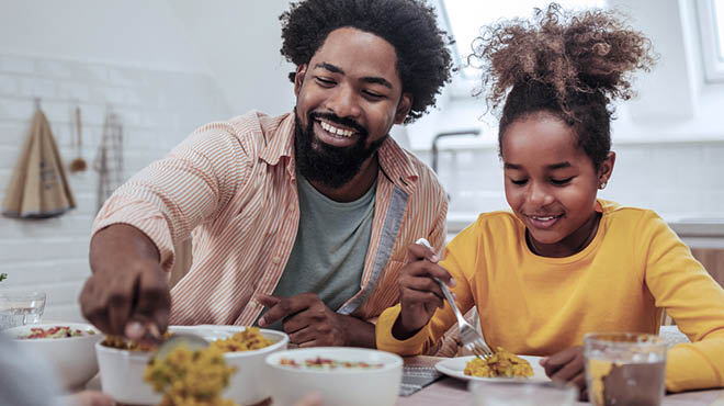 Parent and child making healthy food