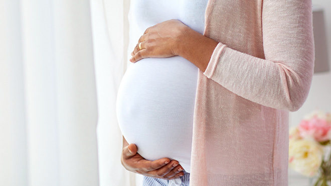 Pregnant woman holding belly