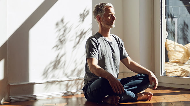 Sitting crosslegged in yoga pose