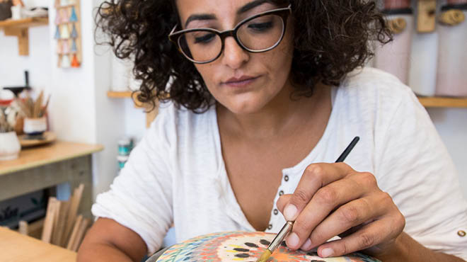 Artist painting pottery