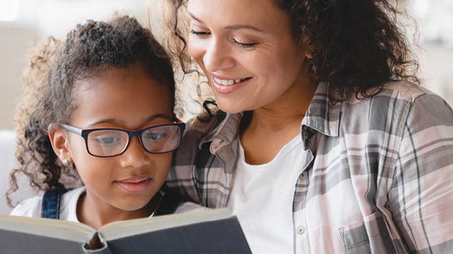 Child and parent reading a book