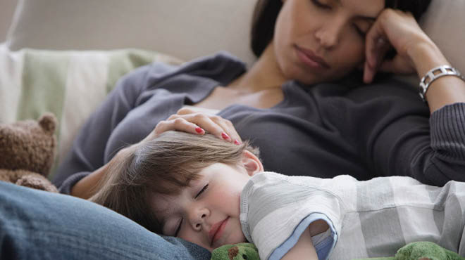 Child sleeping on adult lap