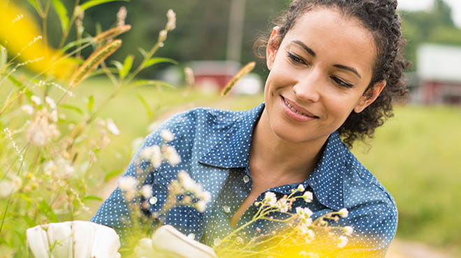 Person with blue shirt flower gardening