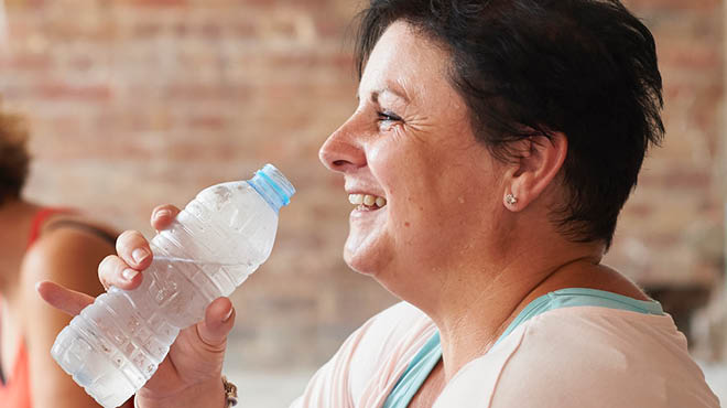 Lifting bottle of water to drink