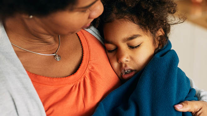 Parent holding sick child