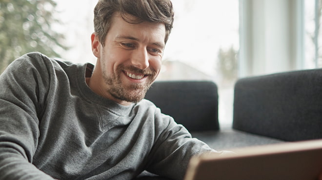 Smiling person wearing grey sweatshirt