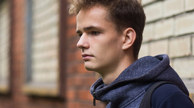 Teenager wearing blue hoodie