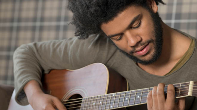 Young adult playing guitar