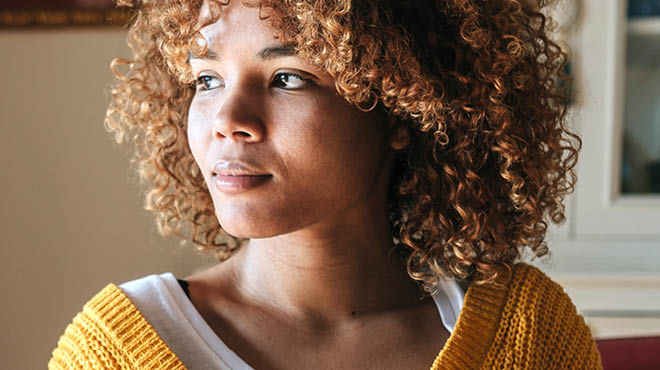 Young person curly hair looking left