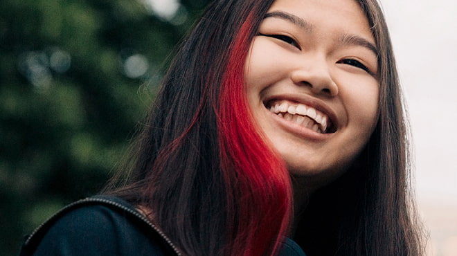 Youth with red streak in dark hair