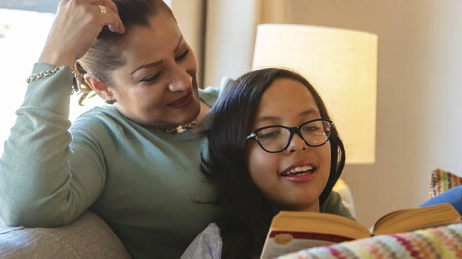 Adult and child reading book