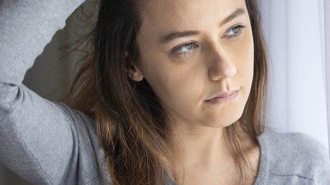 Person's arm up with hand lifting hair