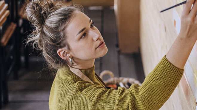 Artist working with arm lifted