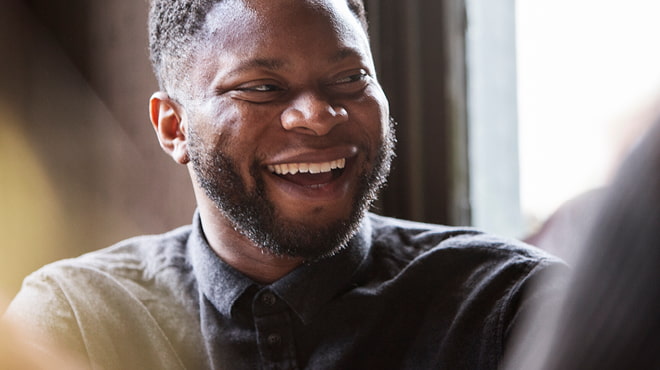 Bearded person laughing