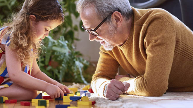 Child and adult playing blocks