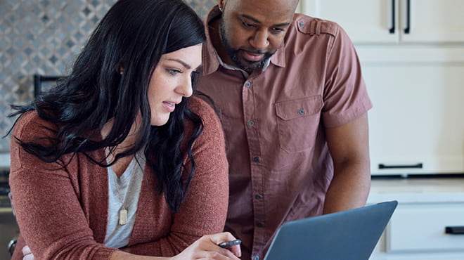 Couple looking at laptop screen