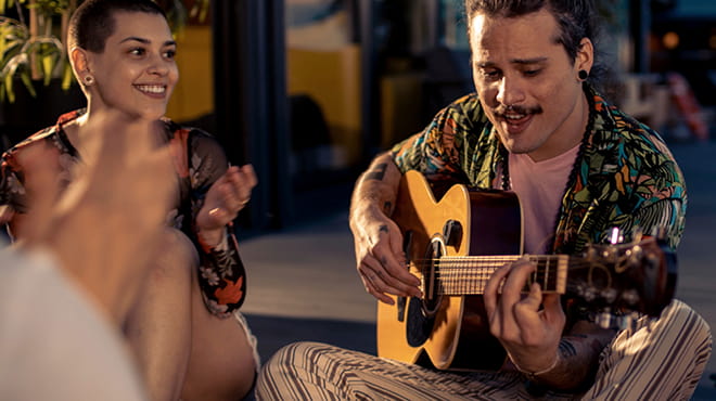 Guitarist playing with people clapping