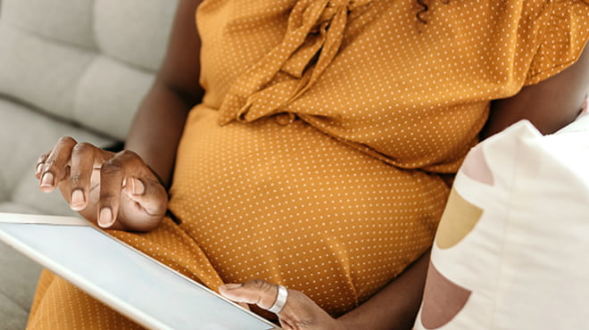 Pregnant person using tablet