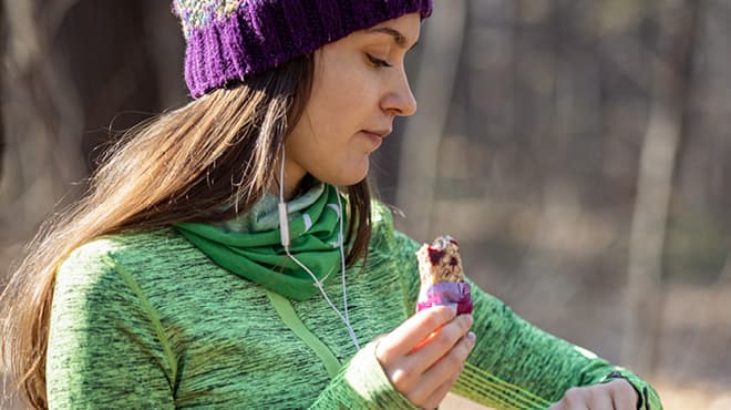 Runner eating protein bar