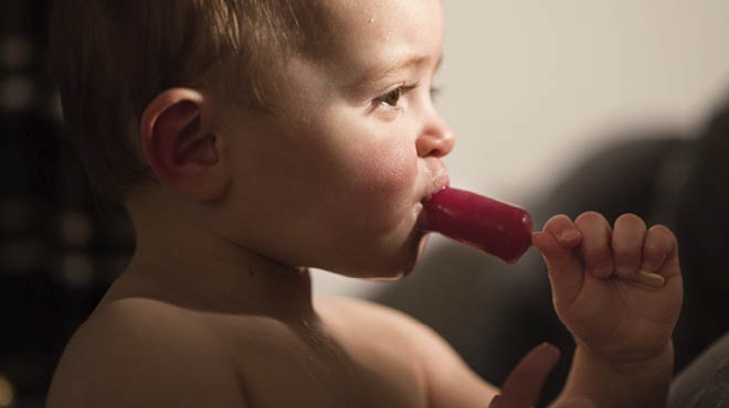 Toddler eating icepop