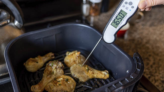 Airfrying chicken with thermometer