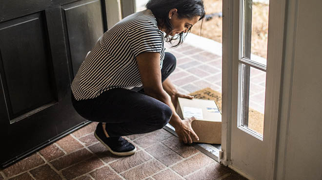 lady picking up delivered package