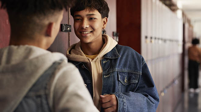 Two kids by school lockers