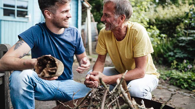 Two people talking by fire ring